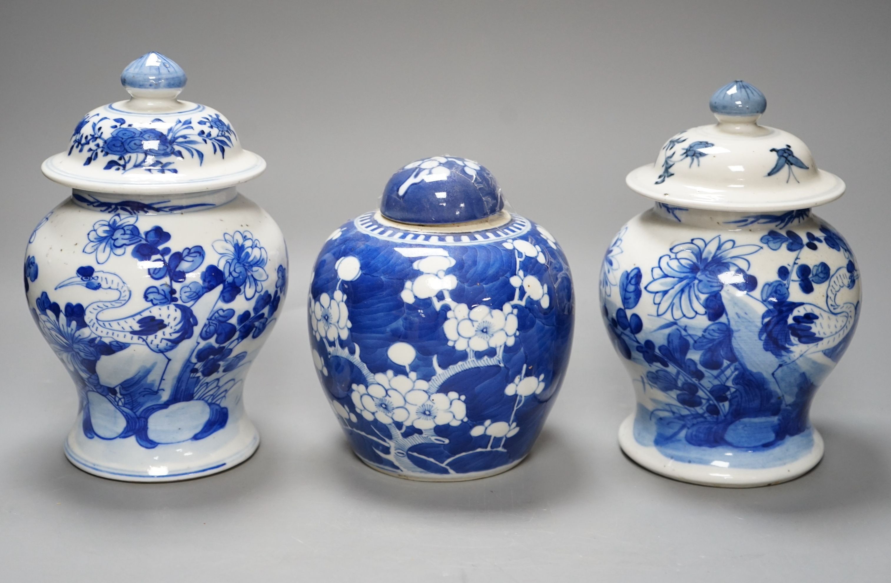 A pair of Chinese jars and covers and a prunus jar and cover circa 1900, jars and covers 21cms high